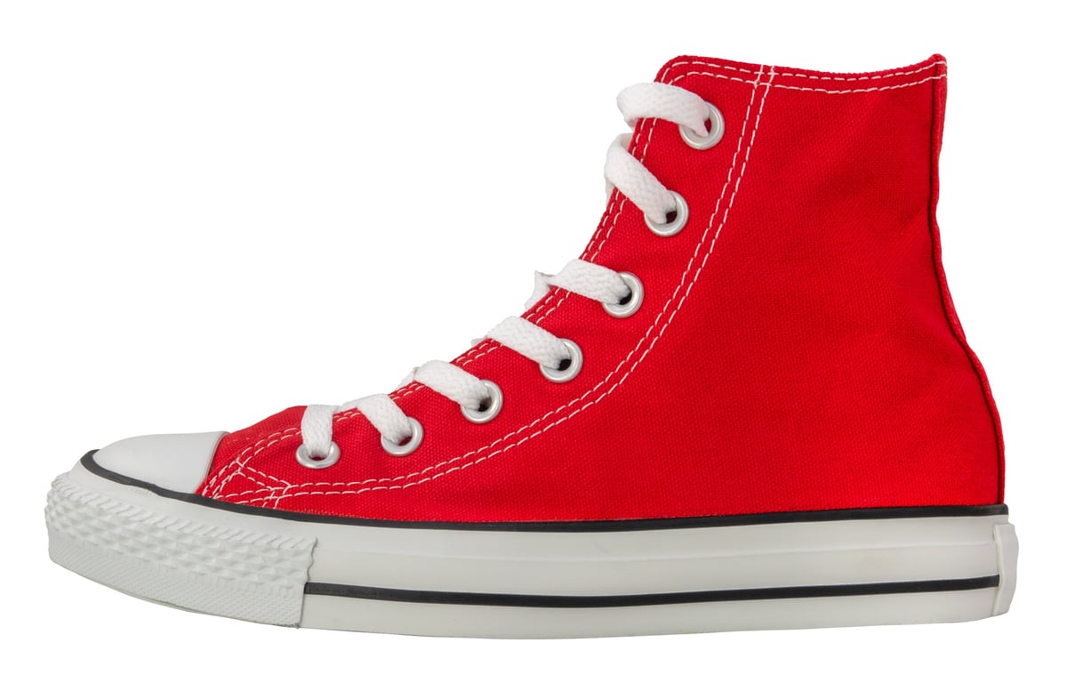 Retro red canvas sneaker on white background