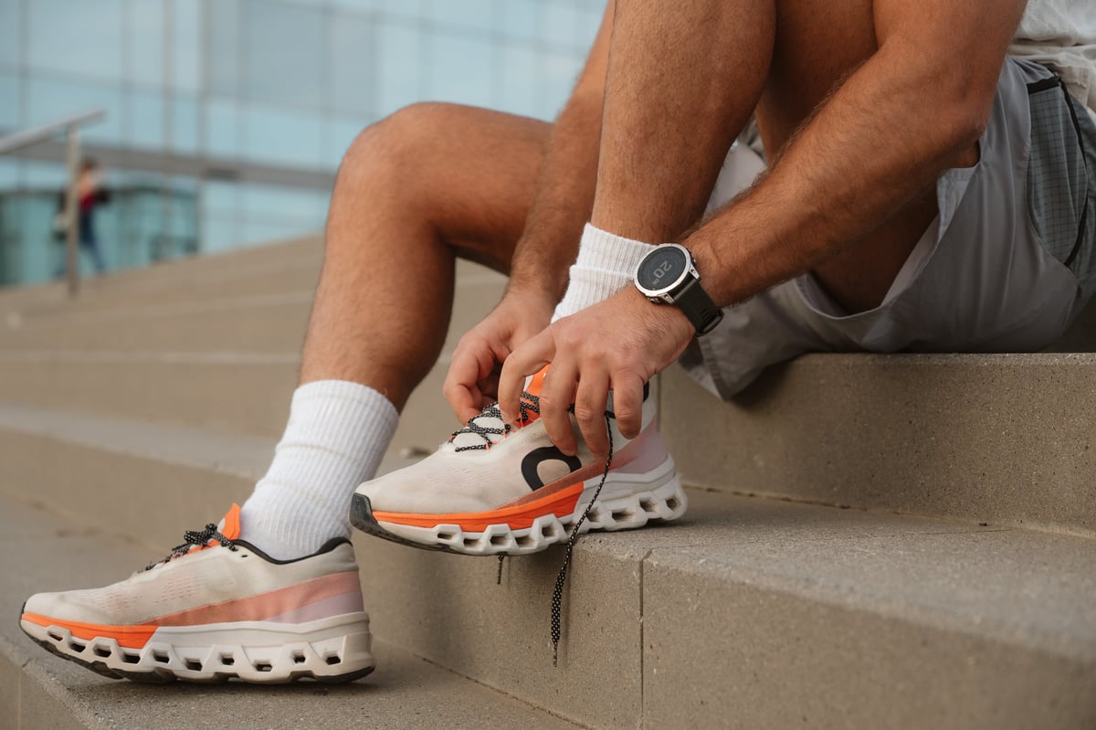 Athlete tying shoelaces on running shoes