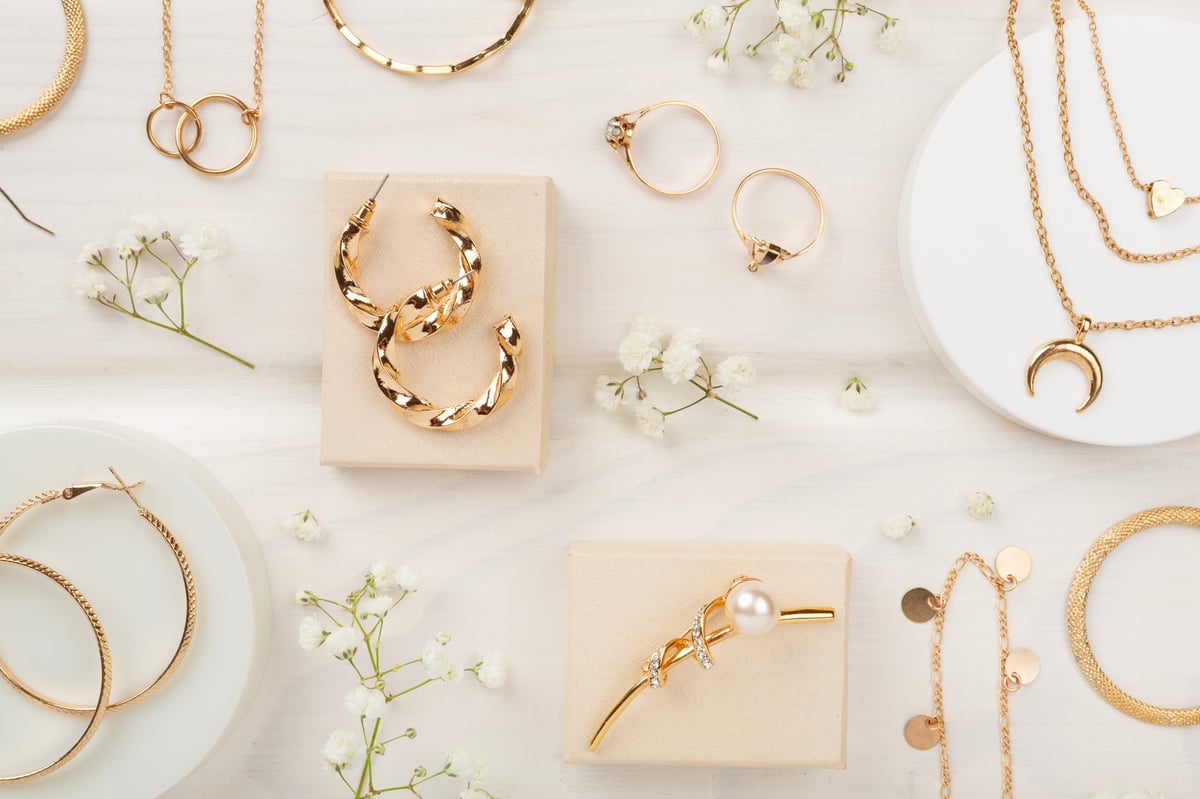 Elegant golden jewelry arranged on a wooden surface