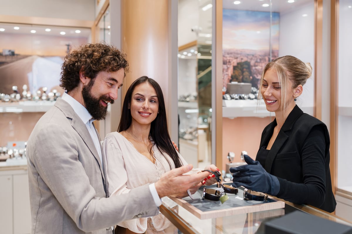 Couple viewing watches displayed in a jewelry store