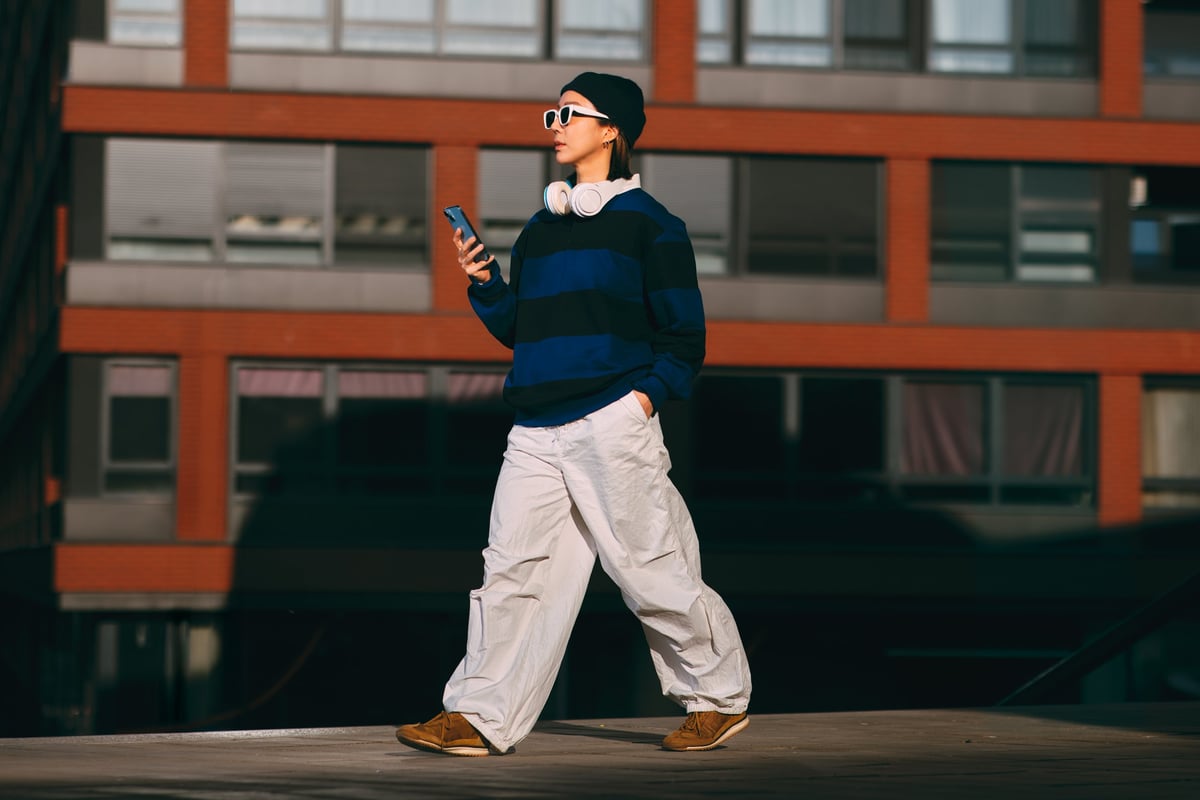 Young woman in streetwear walking in the city