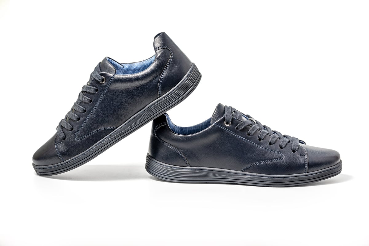 Black leather sneakers isolated on white