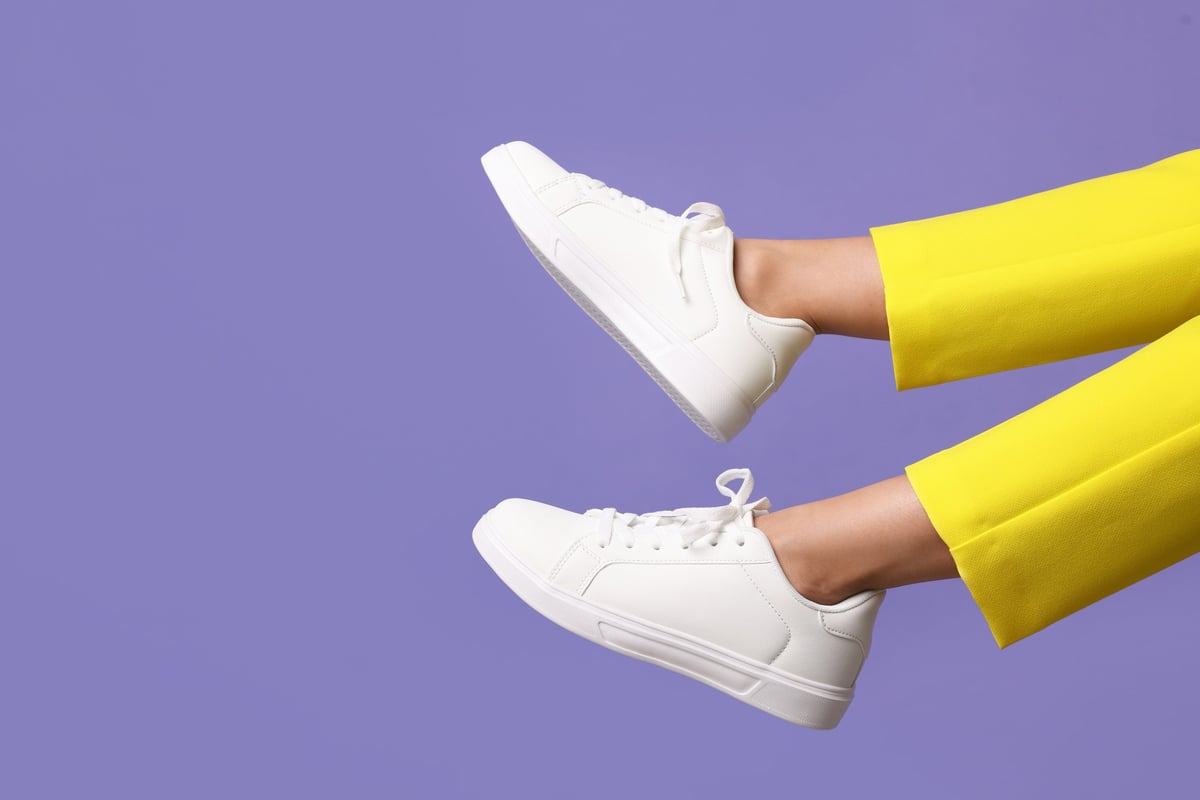 White sneaker on a violet background
